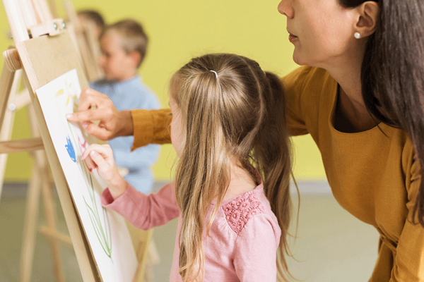 teacher-helping-girl-drawing-class teacher-helping-girl-drawing-class